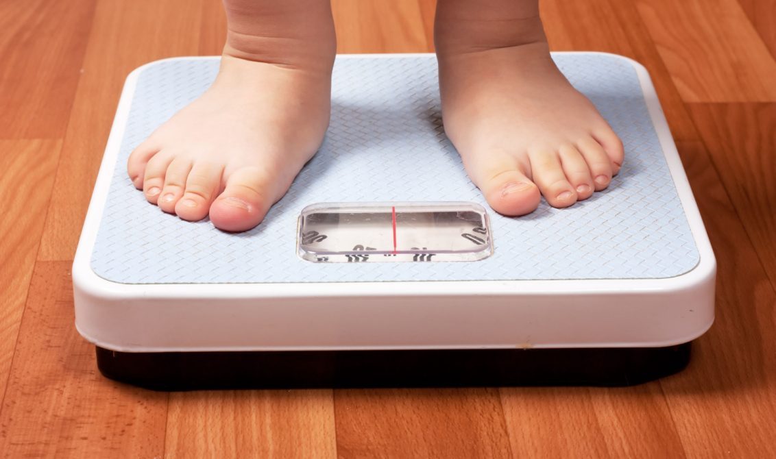 child's feet on scale