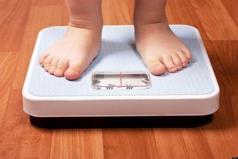 child's feet on scale