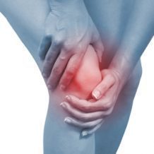hands holding knee in pain
