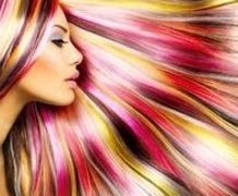 profile of woman with brightly colored hair fanned around her